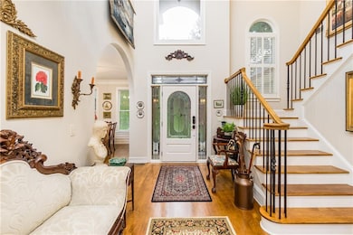 Foyer with a towering ceiling and hardwood / wood-