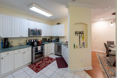 Kitchen with white cabinetry, dark countertops, cr