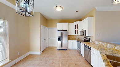 Kitchen featuring light stone counters, appliances