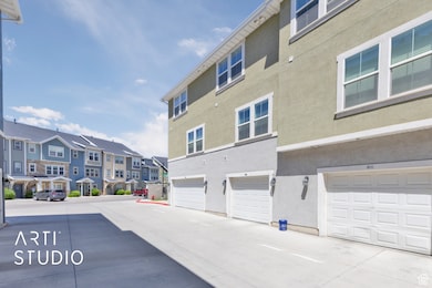 Back of property featuring a residential view, stucco siding, and an attached garage