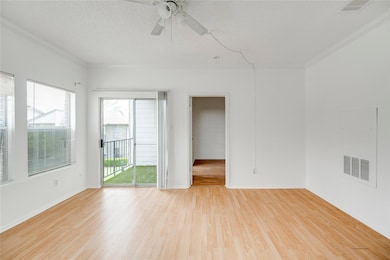 Empty room featuring visible vents, ceiling fan, 