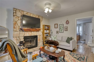 Living room with a ceiling fan, wood finished floo