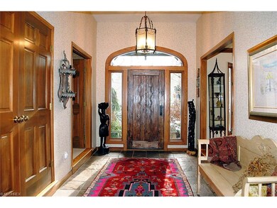 Foyer with beautiful custom door.
