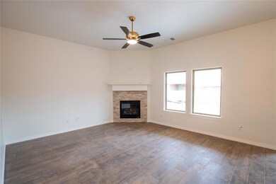 Unfurnished living room with ceiling fan, a firepl