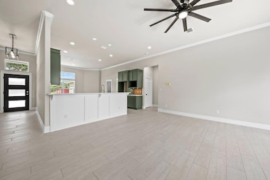 Unfurnished living room featuring ornamental mold