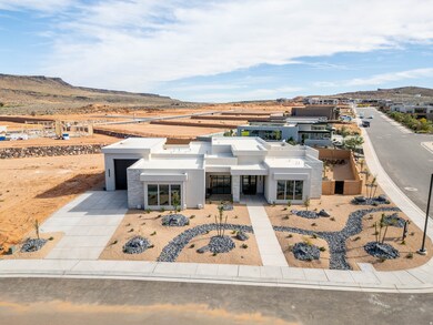 View of front facade featuring a mountain view, stucco siding, and concrete driveway