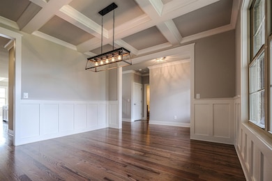 Dining Room with coffered ceilings and Shaker-style chair rail trim.
