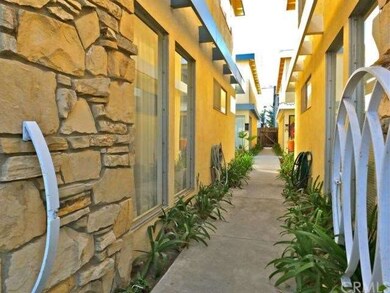 Pleasant garden walkway from street to rear unit &