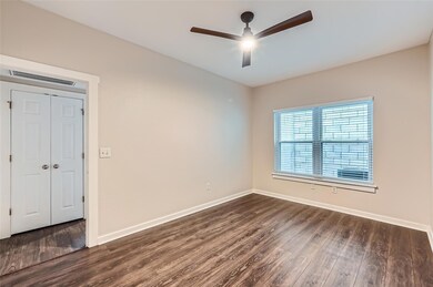 Spare room featuring ceiling fan and dark wood fi