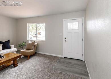 Foyer featuring baseboards and wood finished floors