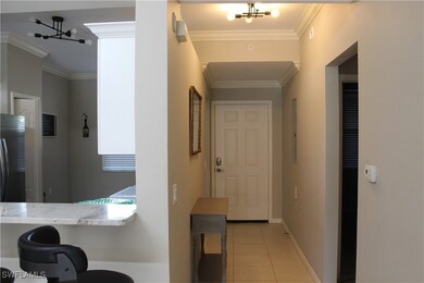 Entry featuring an inviting chandelier, crown mold