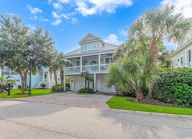 Raised beach house featuring a garage