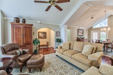 The living room features vaulted ceilings.