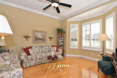 Formal living/office with plantation shutters on b