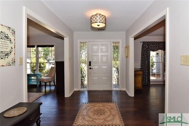 Foyer with custom tile floor design, beautiful fro