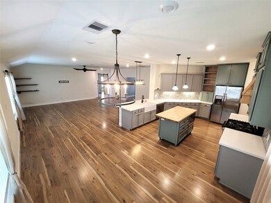 This is a view of the kitchen and family room from the back of the eating area.