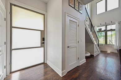 Foyer entrance with a towering ceiling, baseboard