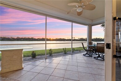 Sunroom with ceiling fan and a water view