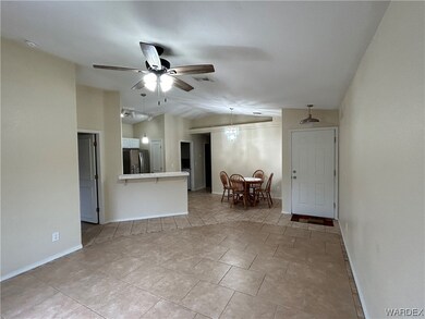 Tiled living room featuring ceiling fan with notab
