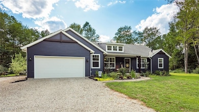 View of front of property with driveway, a porch, a garage, and a front lawn
