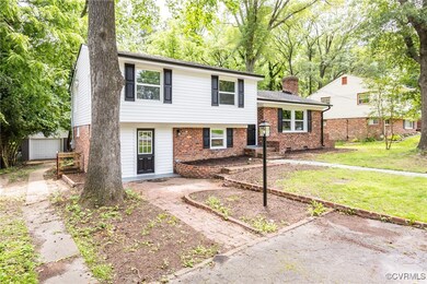 Split level home featuring brick siding, a front l