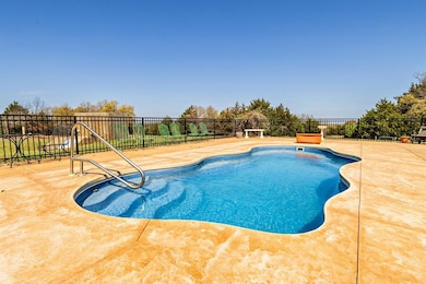 View of swimming pool featuring a fenced in pool, 