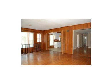 Family room looking into kitchen and formal living