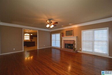 Family room has hardwood floors, crown molding and