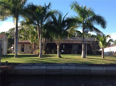 Mature tropical landscaping and concrete seawall. 