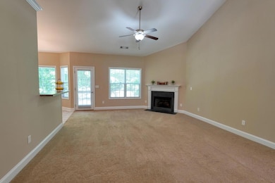 Unfurnished living room featuring light carpet, ce