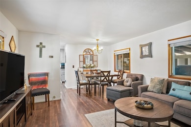 Living area with a chandelier, dark wood finished