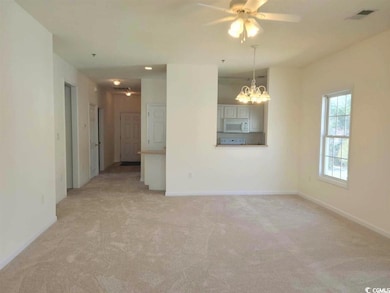 Empty room featuring light carpet, baseboards, cei