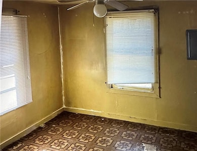 Spare room with electric panel and ceiling fan