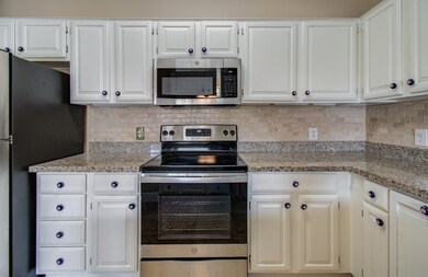 Another view of kitchen featuring electric range w