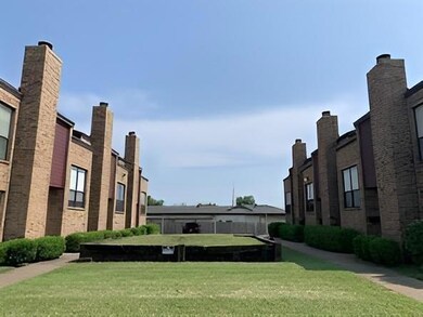 View of home's community with a lawn