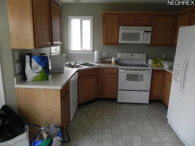 The cook is sure to enjoy preparing meals in the kitchen.  The kitchen featuring plenty of counter tops, cabinets, stainless sink, garbage disposal, two windows to let the natural sunlight in and fully applianced!!