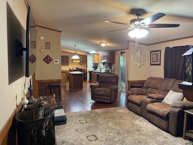 Living room featuring ornamental molding, dark har