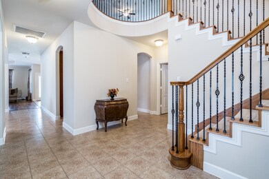 You will love the soaring two-story entry with a dramatic staircase.