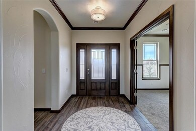 Lots of natural light to enjoy thru this entryway with crown molding, subtle archway and entrance to the 2nd living that features extra trim details and bead board accents.