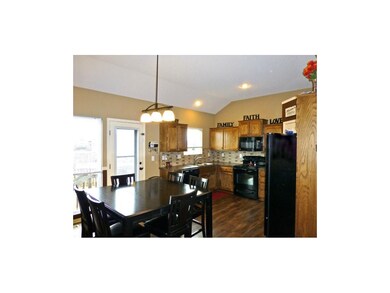 Light filled kitchen, wood floors and dark cabinet