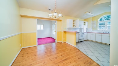 Kitchen featuring white electric range oven, open shelves, white cabinets, a sink, and a chandelier