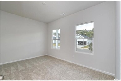 Spare room featuring light carpet