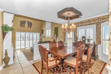 Tiled dining space featuring a textured ceiling, c