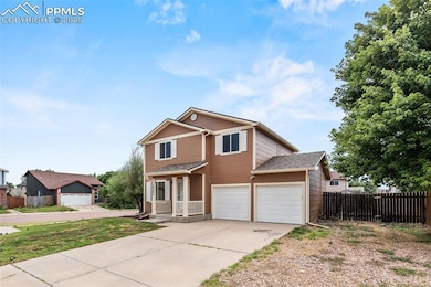 Traditional-style home featuring driveway and a garage