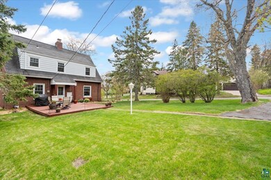 View of grassy yard featuring a deck