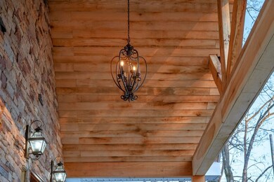 Wood under-hang on front porch that has now since been stained along with chandelier for added charm.