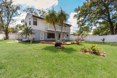 large fenced in back yard with deck.