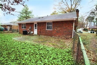 Rear view of house featuring central AC