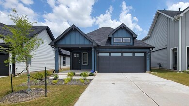 View of front of house featuring driveway, a fron