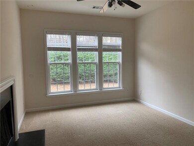 Unfurnished living room with ceiling fan, carpet floors, and plenty of natural light